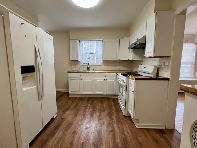 kitchen with sink, dark hardwood / wood-style floors, white cabinets, white appliances, and backsplash