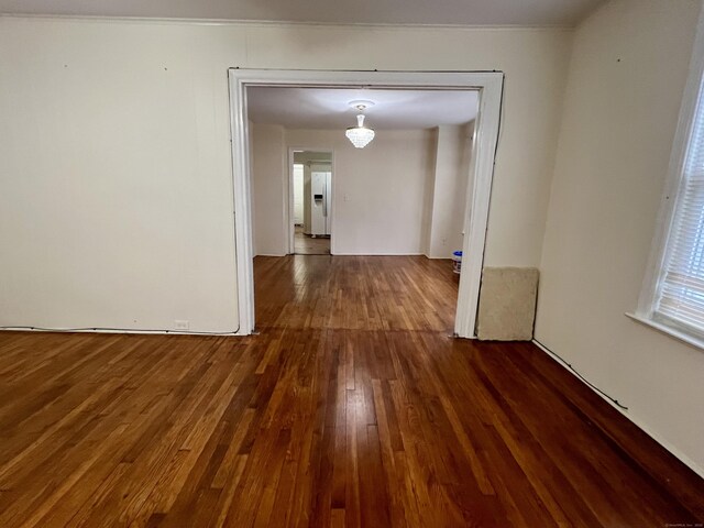 hallway featuring dark hardwood / wood-style flooring and crown molding