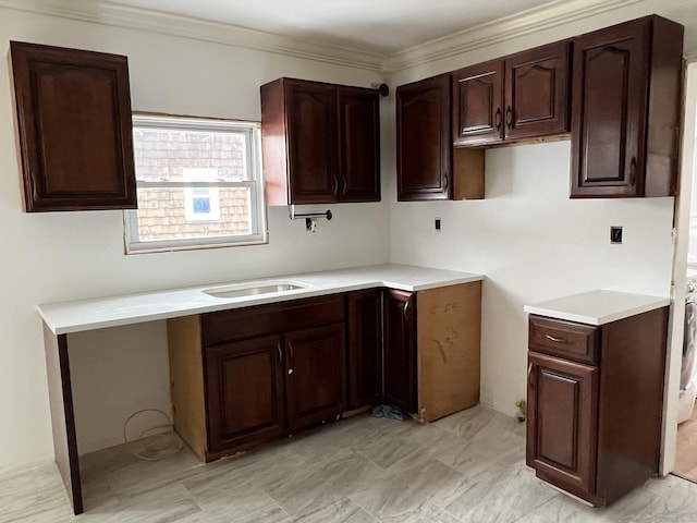 kitchen with ornamental molding, dark brown cabinetry, and sink