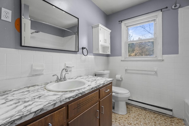 bathroom with toilet, tile walls, tile patterned floors, a baseboard radiator, and vanity