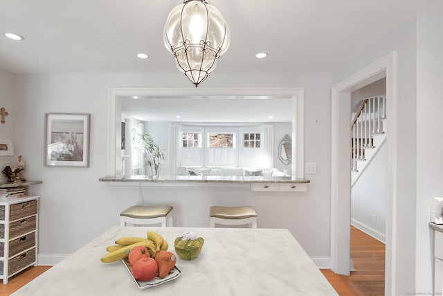 dining area featuring a chandelier and light wood-type flooring