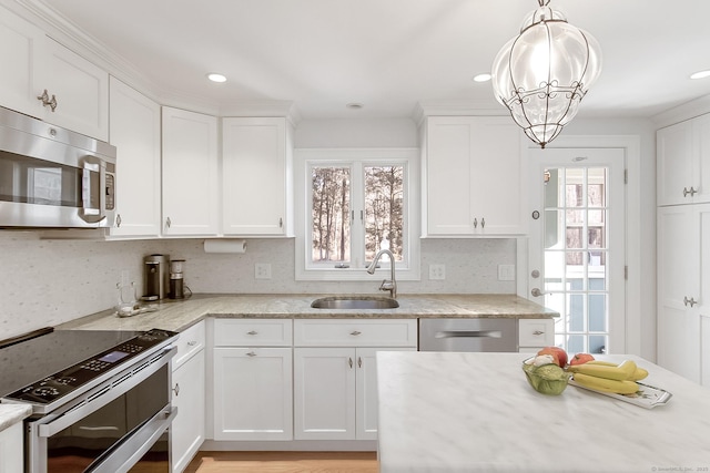 kitchen with stainless steel appliances, white cabinets, and sink