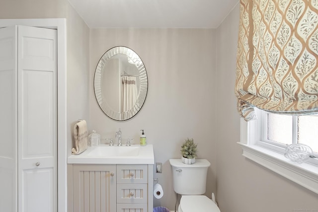 bathroom with toilet and vanity