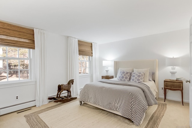 bedroom featuring light carpet and multiple windows