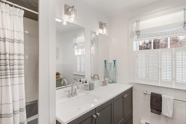 bathroom with tile walls and vanity