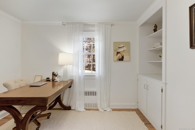 office space with radiator, crown molding, and light hardwood / wood-style floors