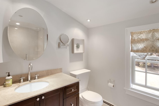 bathroom featuring toilet, vaulted ceiling, vanity, and a baseboard radiator