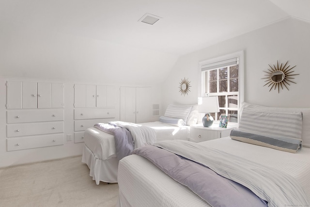 carpeted bedroom with lofted ceiling