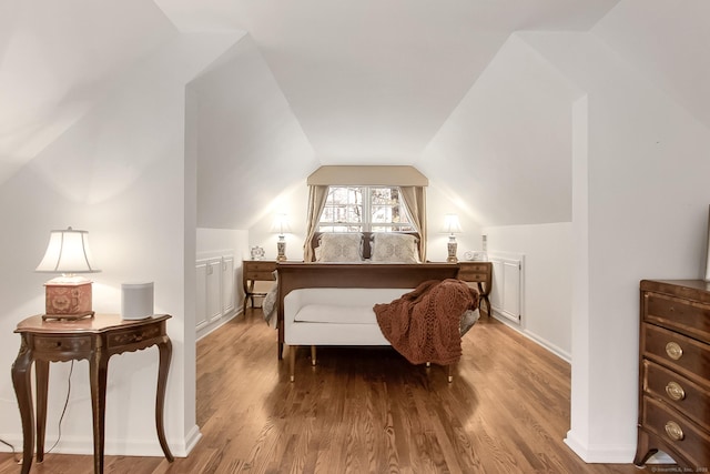 bedroom featuring lofted ceiling and hardwood / wood-style flooring