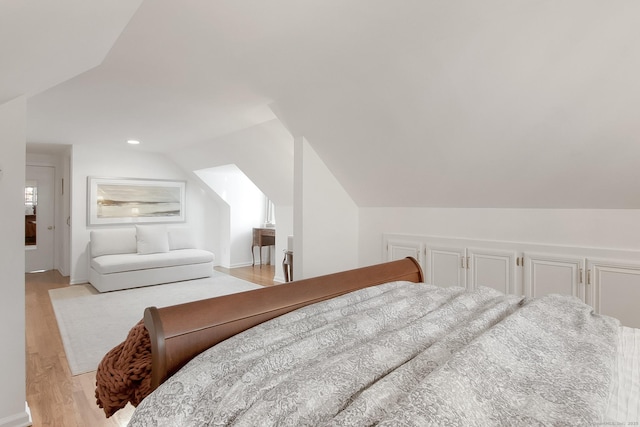 bedroom featuring vaulted ceiling and light hardwood / wood-style flooring