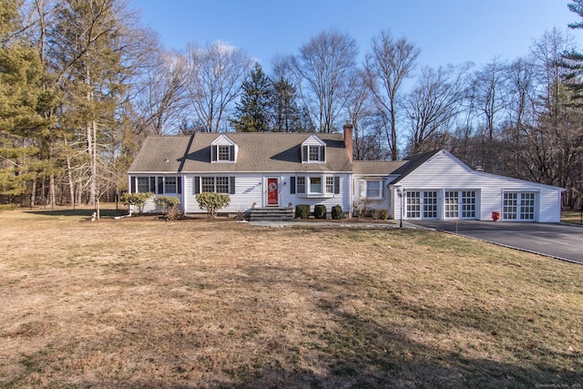 new england style home featuring a front yard