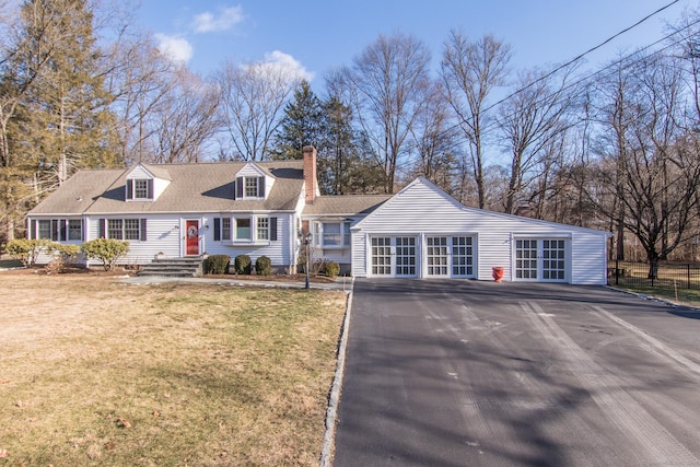 cape cod house with a front lawn