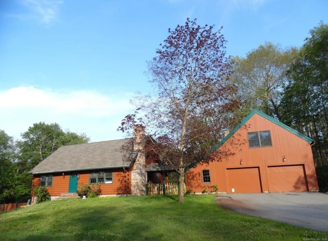 view of front of house featuring a garage and a front lawn