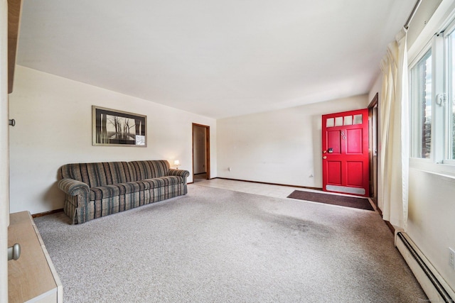 unfurnished living room with a baseboard radiator and carpet