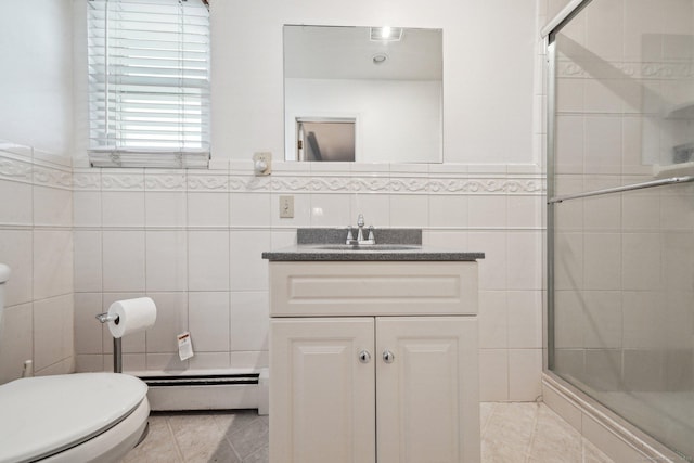 bathroom featuring tile walls, an enclosed shower, vanity, and a baseboard heating unit