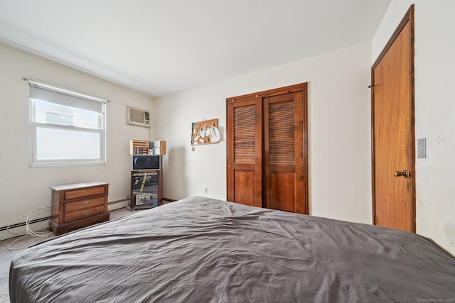 bedroom featuring a wall unit AC, a closet, and a baseboard radiator