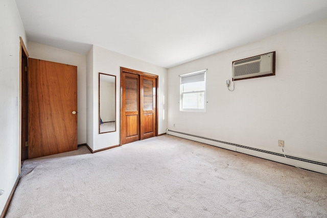 unfurnished bedroom with a baseboard heating unit, light colored carpet, a closet, and a wall mounted air conditioner