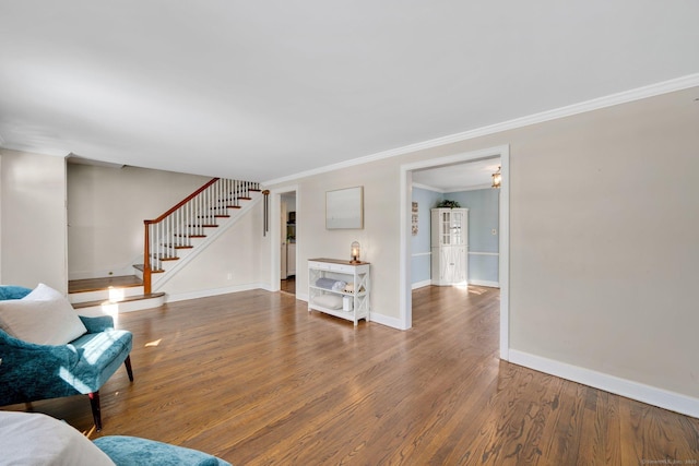 unfurnished living room featuring ornamental molding and hardwood / wood-style flooring