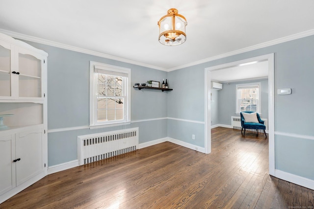 unfurnished room with an AC wall unit, radiator heating unit, dark hardwood / wood-style flooring, and a chandelier