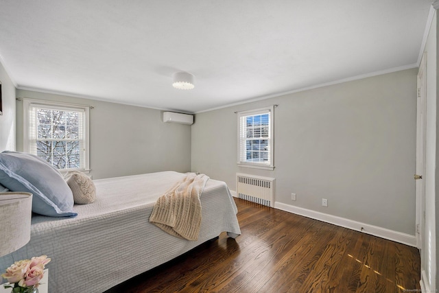 bedroom with radiator, an AC wall unit, dark hardwood / wood-style flooring, and ornamental molding