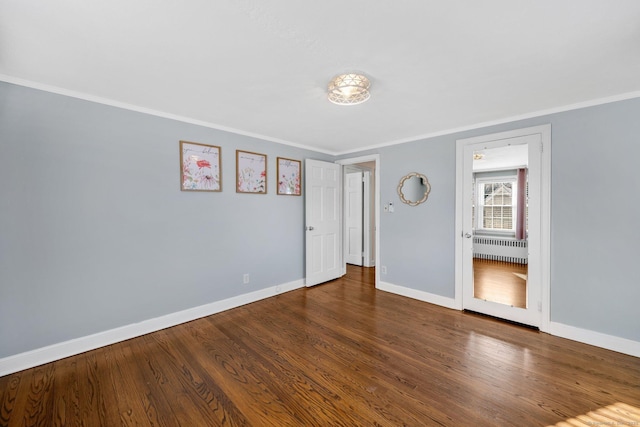 unfurnished bedroom with crown molding and hardwood / wood-style flooring