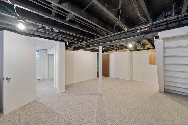 basement featuring carpet floors and a baseboard radiator