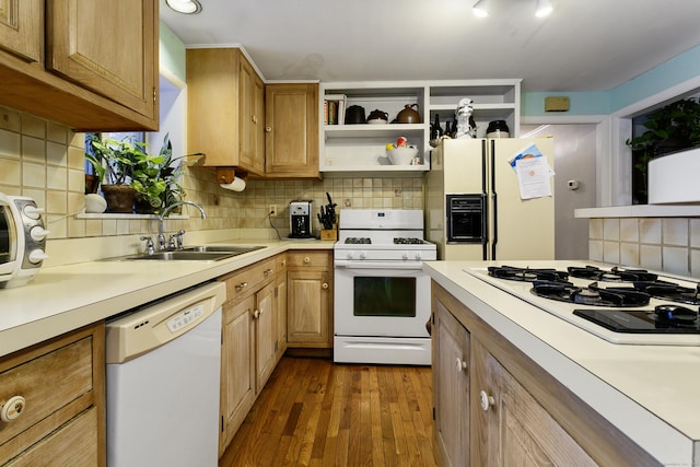 kitchen with dark wood-type flooring, decorative backsplash, sink, and white appliances