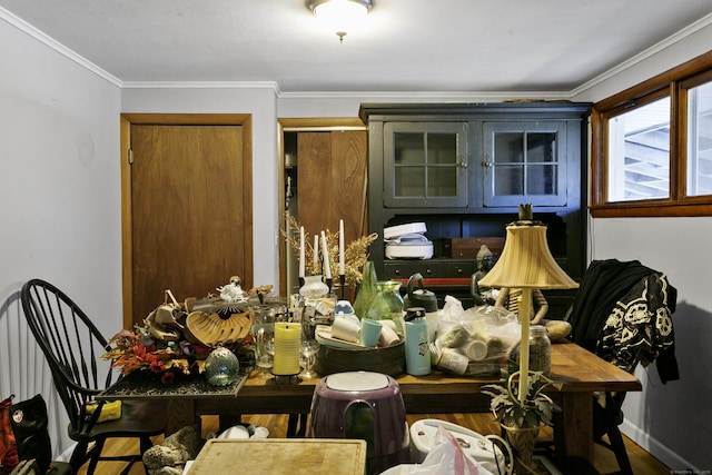 dining room with wood-type flooring and ornamental molding