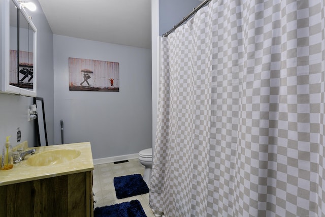 bathroom featuring toilet and vanity