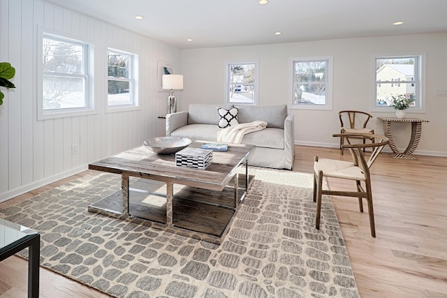 living room with wooden walls and light wood-type flooring