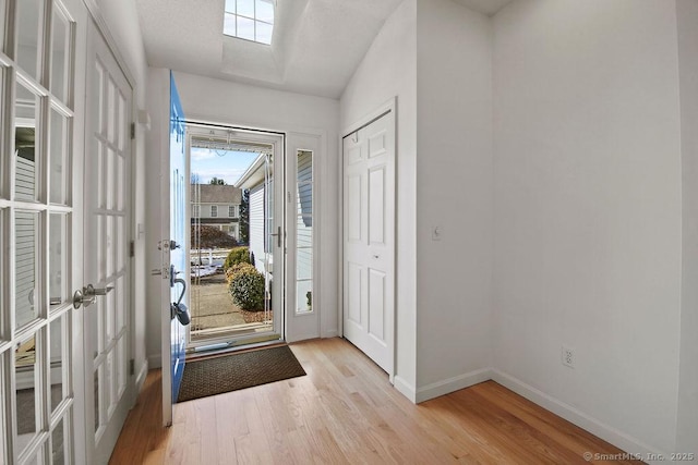 foyer entrance with french doors and light wood-type flooring