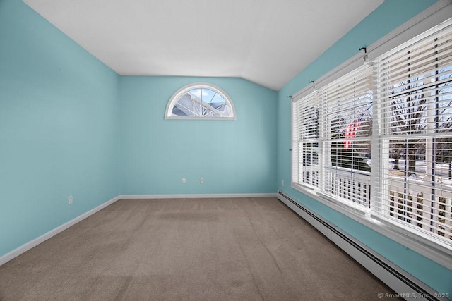 empty room with lofted ceiling, light colored carpet, and baseboard heating