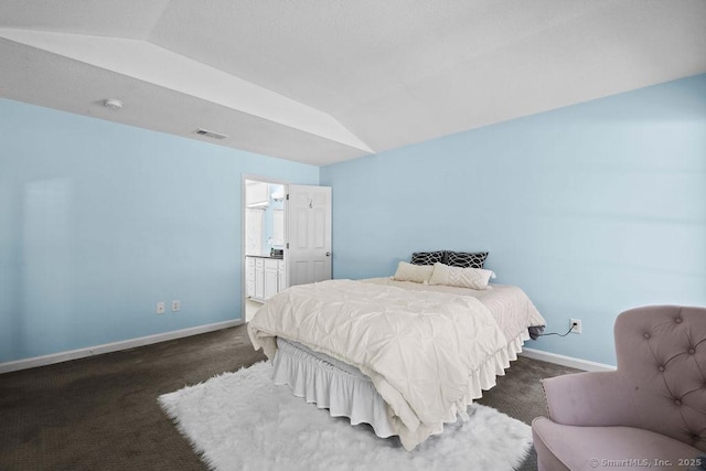 bedroom with dark colored carpet and lofted ceiling