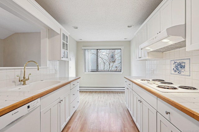 kitchen with white appliances, white cabinetry, tasteful backsplash, and tile counters