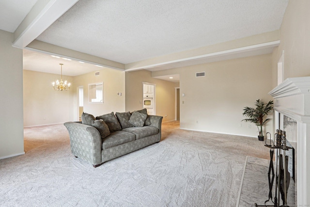 living room featuring beamed ceiling, light carpet, a chandelier, and a textured ceiling