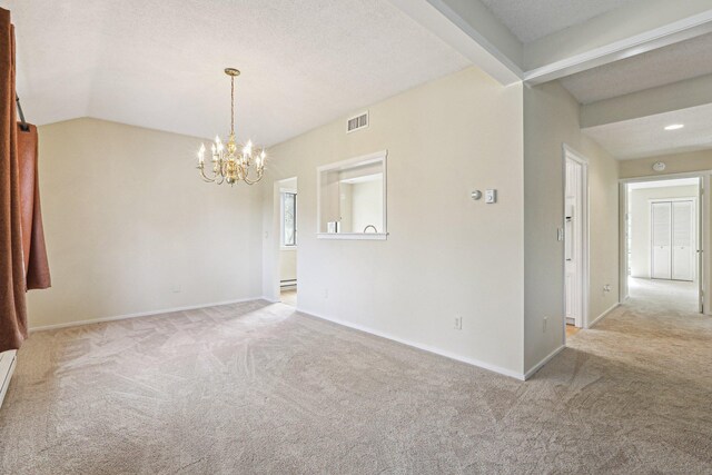 carpeted empty room with a notable chandelier, a textured ceiling, and vaulted ceiling with beams