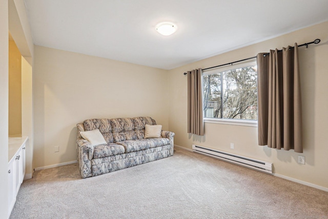 living area featuring a baseboard heating unit and light colored carpet