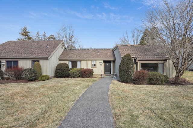 single story home with a front lawn