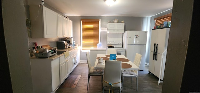 kitchen with white cabinetry, dark hardwood / wood-style floors, and white appliances