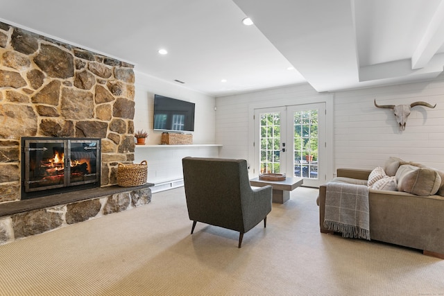 living room featuring french doors, carpet floors, a fireplace, and a baseboard heating unit