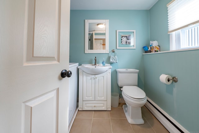 bathroom with vanity, toilet, baseboard heating, and tile patterned flooring