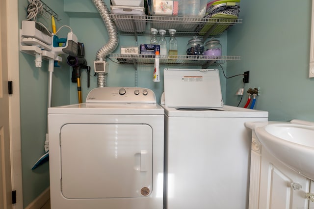 clothes washing area with sink and washing machine and dryer