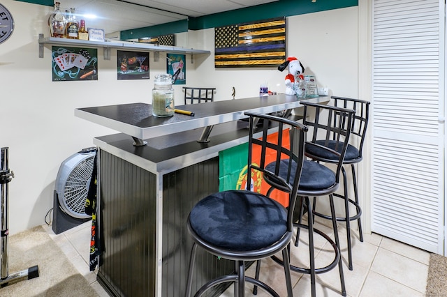 bar featuring light tile patterned floors