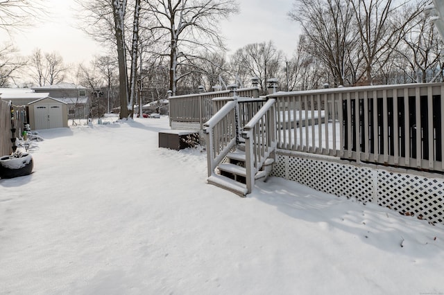 snow covered deck featuring a storage unit