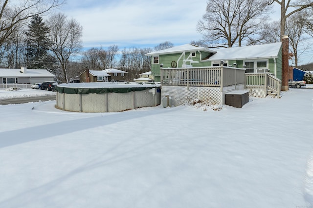 snowy yard featuring a swimming pool side deck