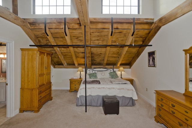 bedroom featuring light carpet, wooden ceiling, and lofted ceiling with beams