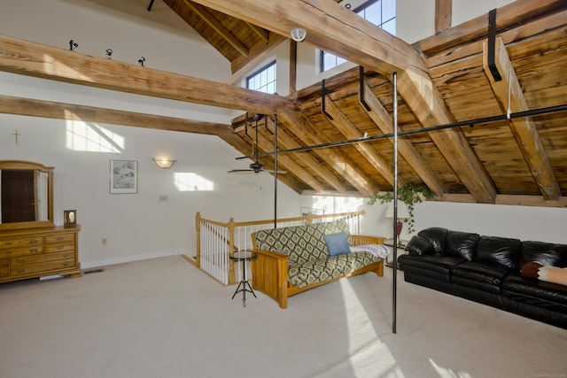 interior space with wood ceiling, beamed ceiling, carpet flooring, and a wealth of natural light