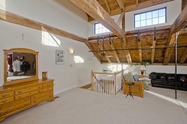 sitting room with beamed ceiling, carpet, and wood ceiling