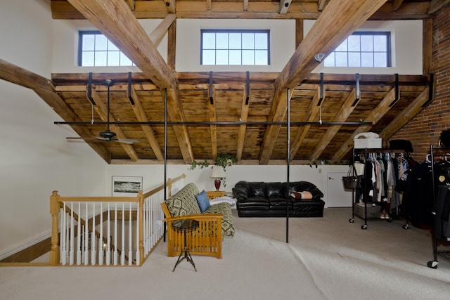 interior space with beam ceiling and a wealth of natural light