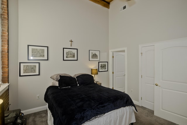 bedroom with high vaulted ceiling, dark carpet, and beamed ceiling